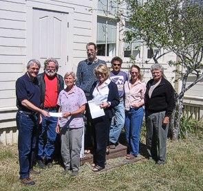 Jim Moorhead handing a check for $5,000 for a dishwasher for the Community Center, a grant awarded to Caspar Community by the Community Foundation of Mendocino County.